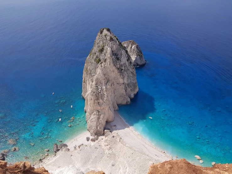 blue lagoon and sand beach with a rock outcropping