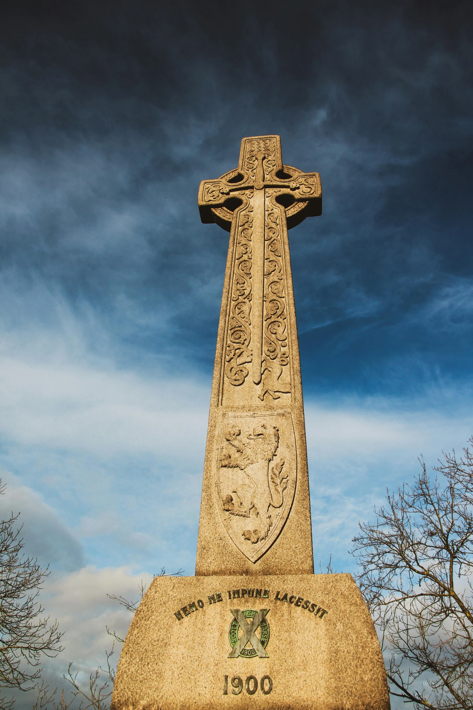 the war memorial in a city square under a blue sky