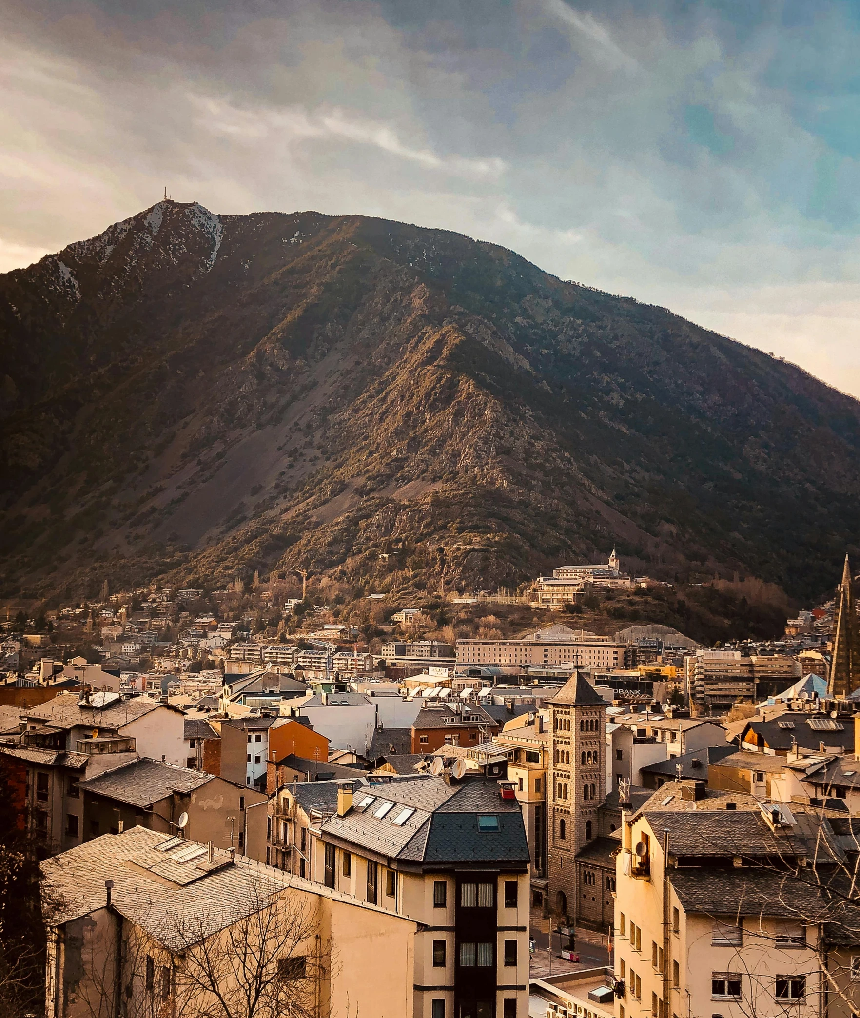 a city is shown in the foreground with mountains in the background