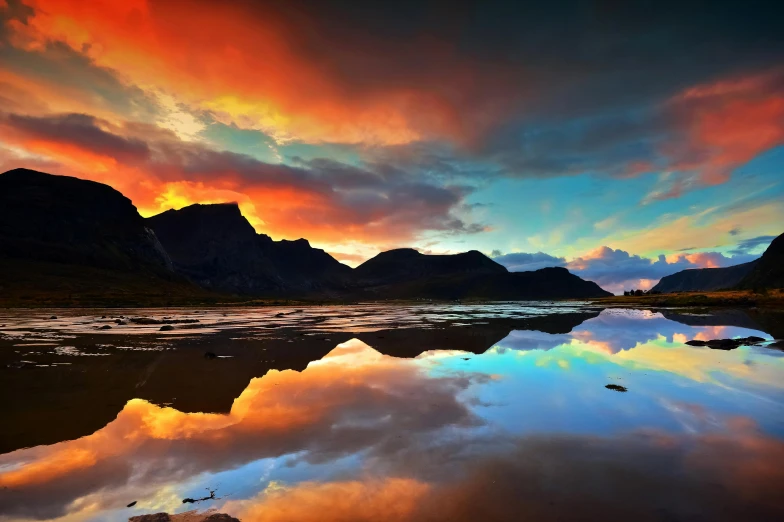 a body of water with mountains in the background