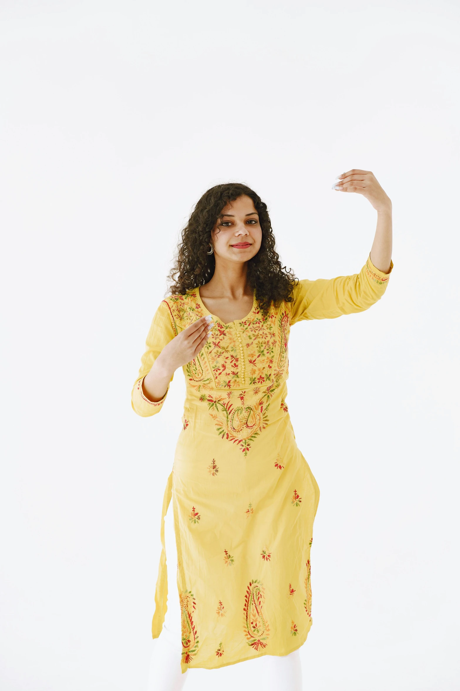 a woman standing wearing a yellow dress and posing for a po