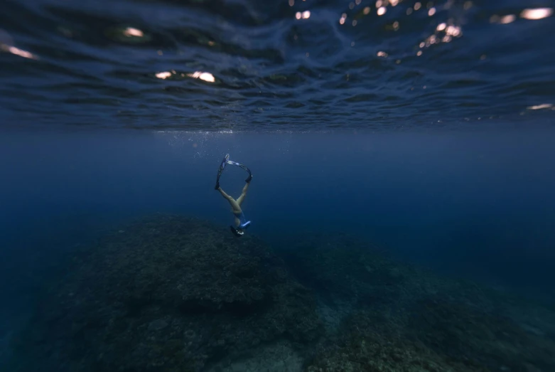 a man is swimming in the water with his arms up