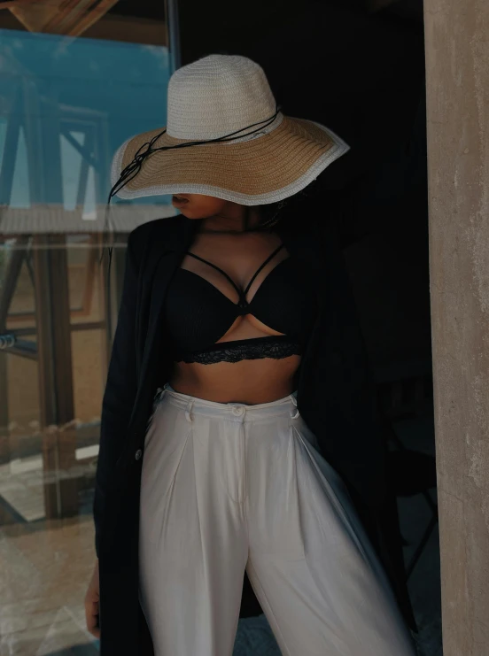 woman in a black bikini top with a hat on her head