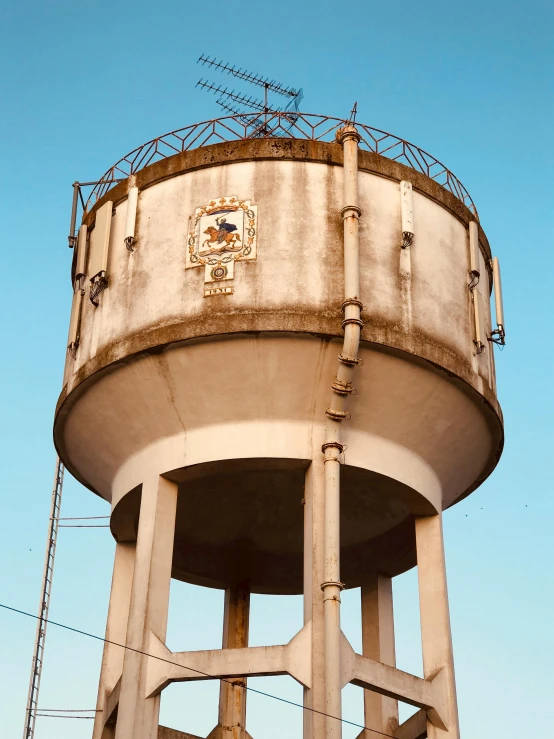 a water tower that has barbed wire on top