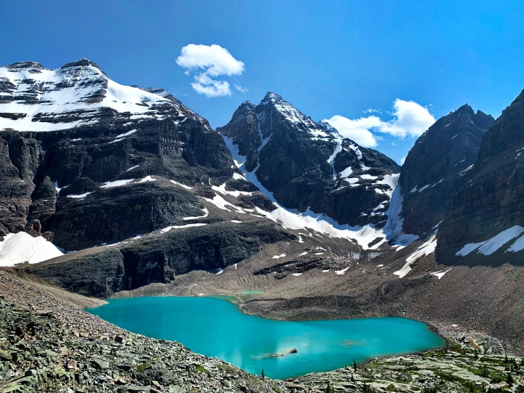 the mountain is full of water that reflects in the blue lake