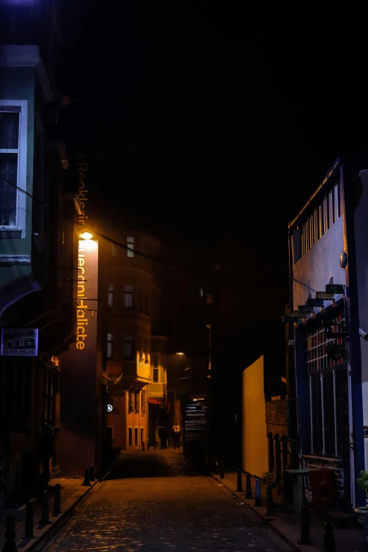 a small town at night with a lamp post and building