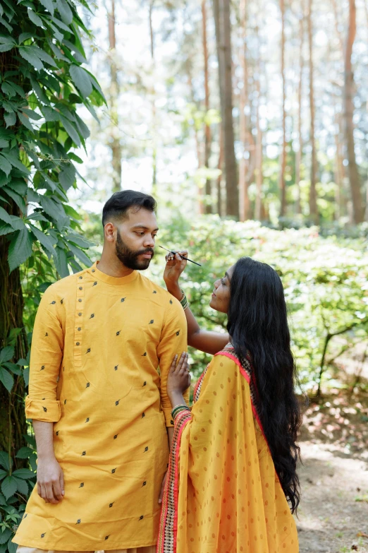 an indian couple dressed up in traditional wear posing for a picture