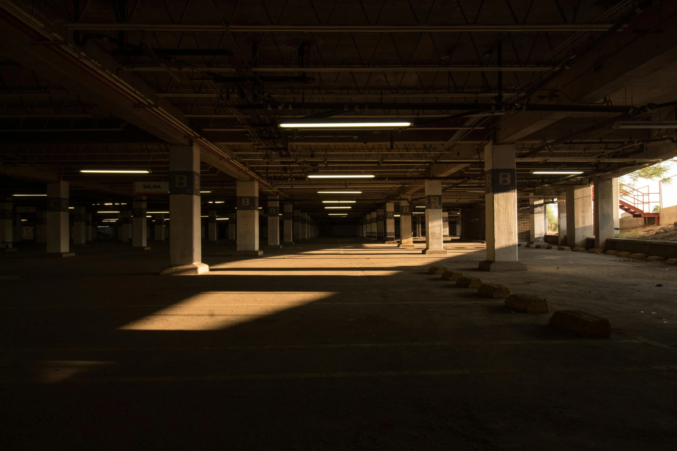 a dark abandoned building is lit by the sun