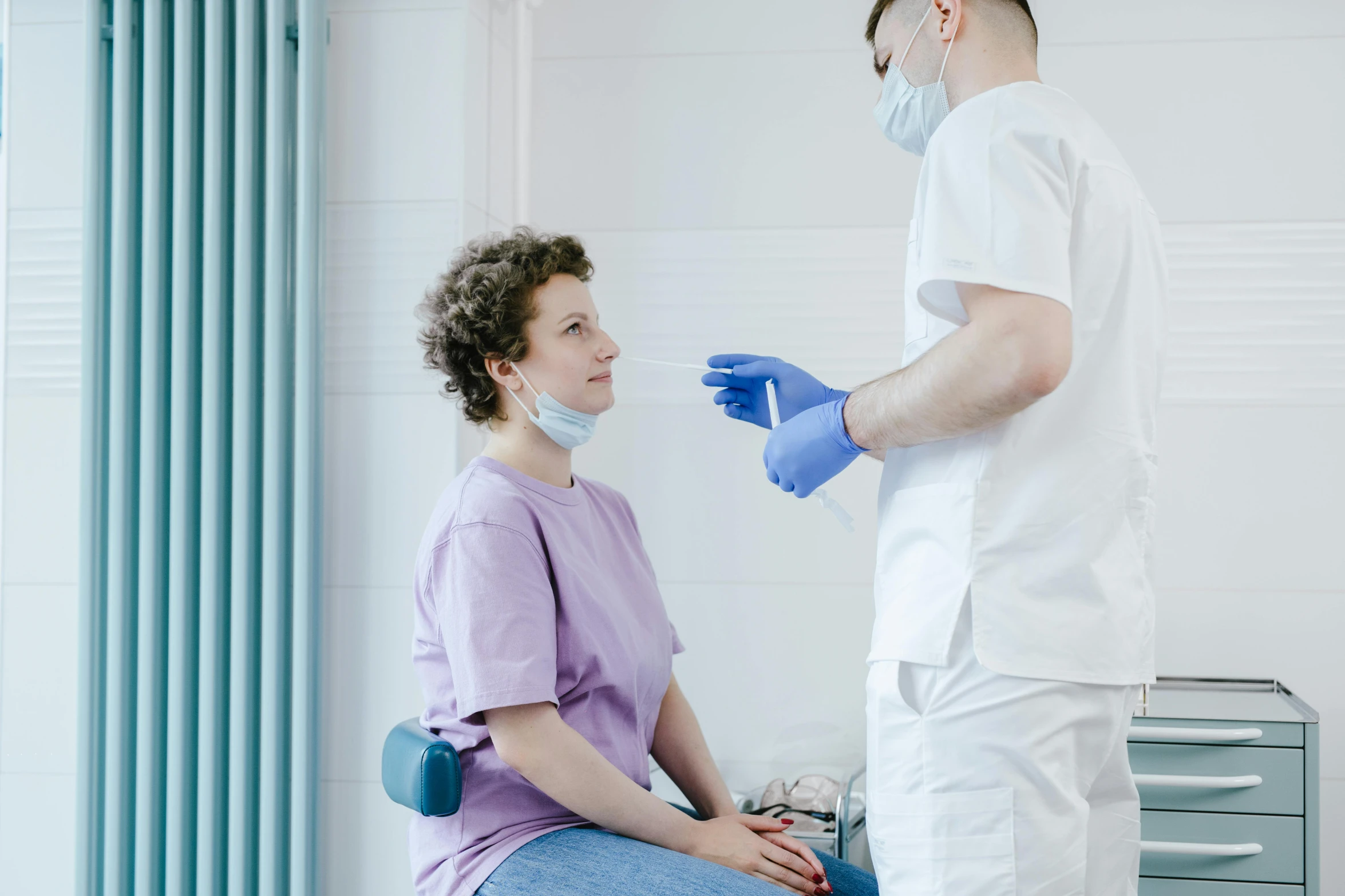 an image of two doctors examining someone in the doctor's office