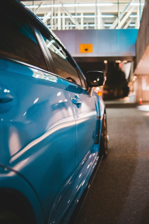 two cars parked next to each other at a parking garage