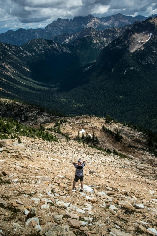 there is a male hiker on the top of this mountain