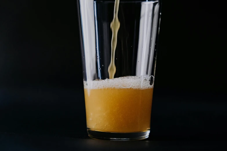 a clear glass full of orange juice