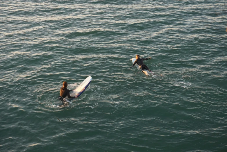 people are surfing in the open water on surf boards