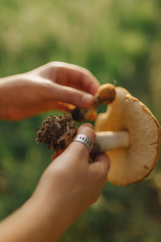 a person with their hands in the shape of the tail of a mushroom