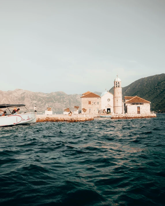 a boat out on the ocean near a small island