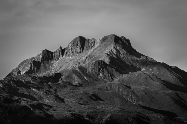 the mountain with snow on it is in black and white