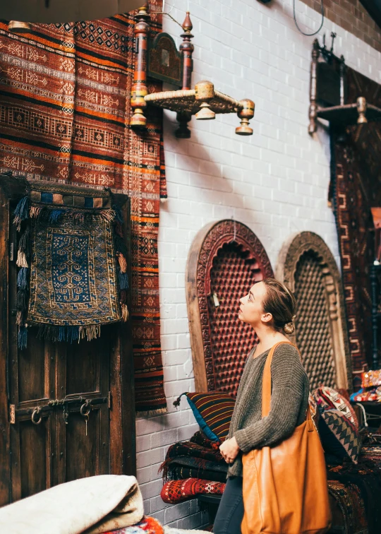 a woman sitting on a bench in a shop