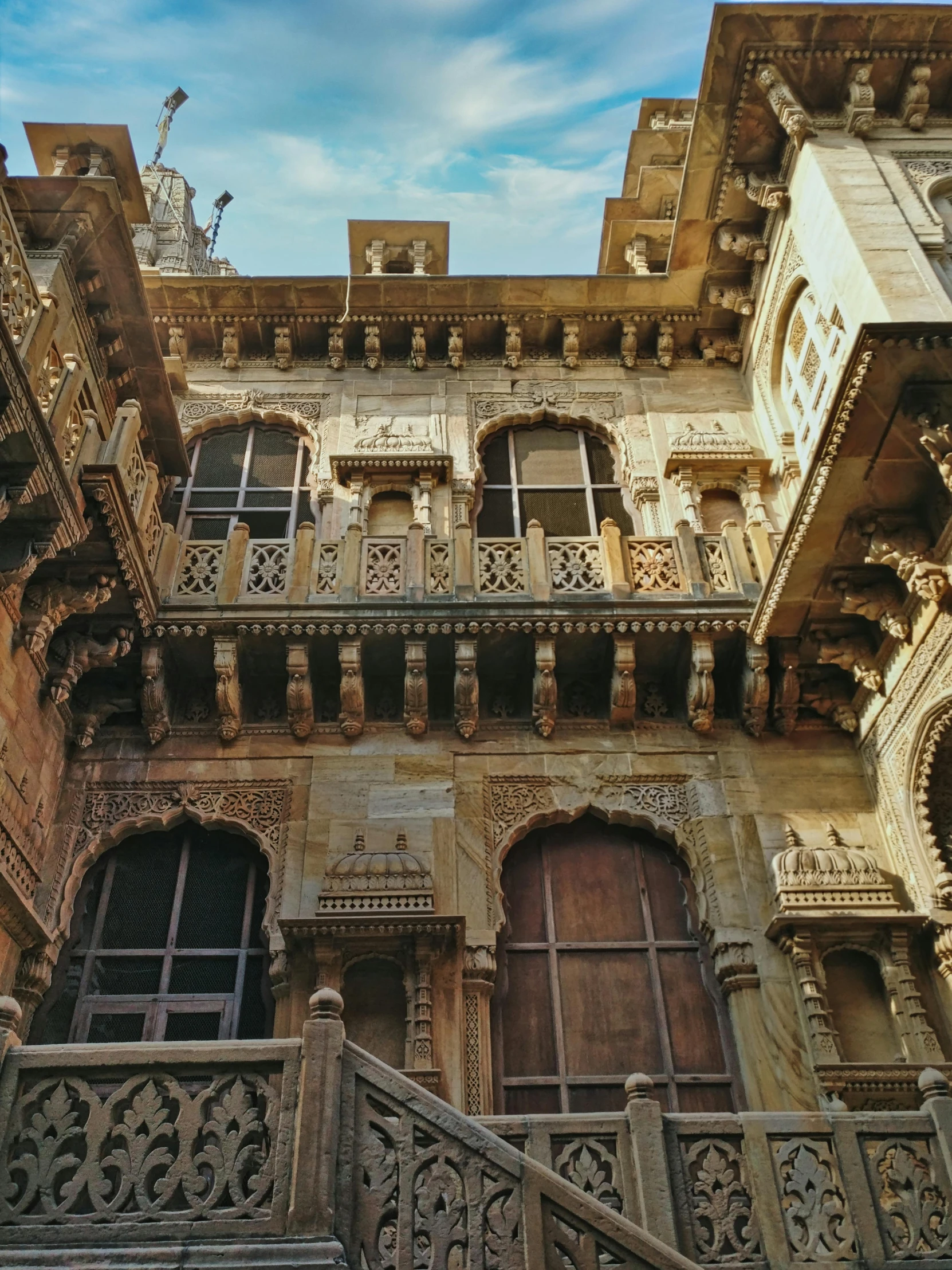 a building with stone details and doors that have a handrail