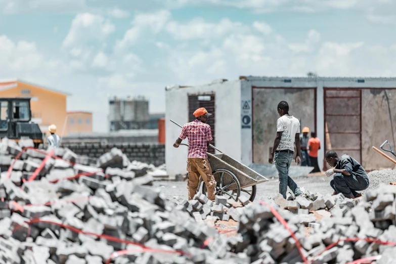 a group of people move around the rubble