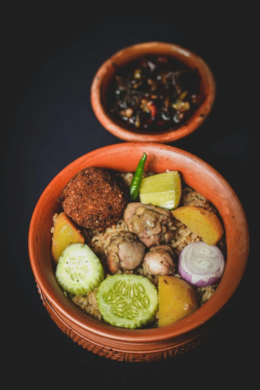 the bowl has several vegetables inside and one on it