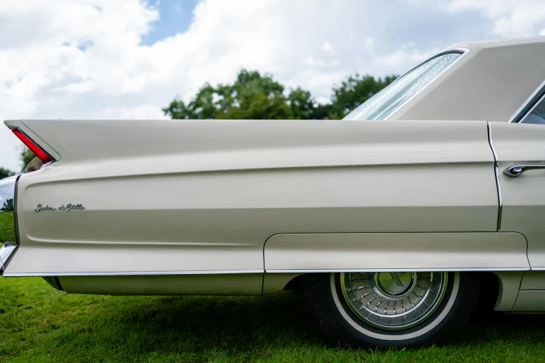 a white classic car parked in a field