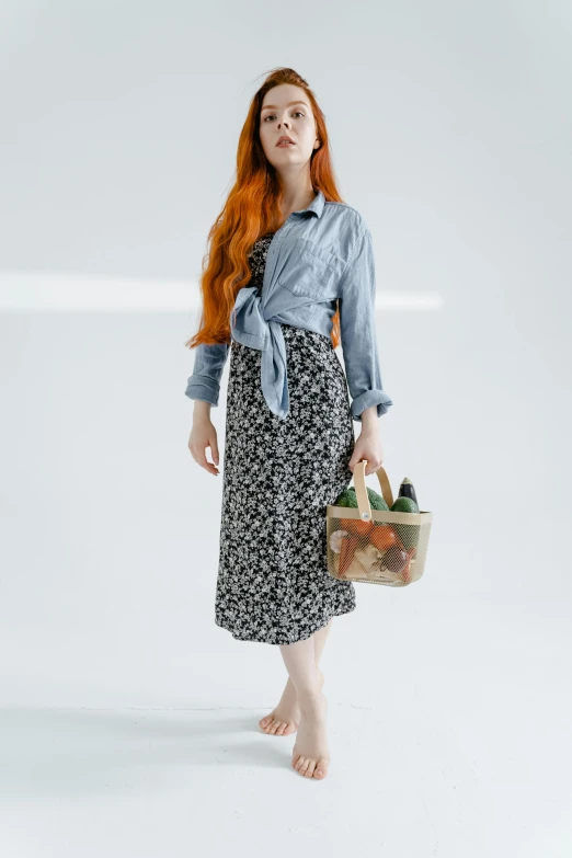 a red headed girl in dress with a basket