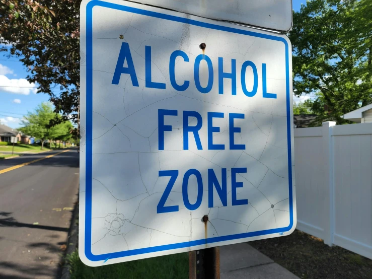 there is a blue and white sign that reads alcohol free zone