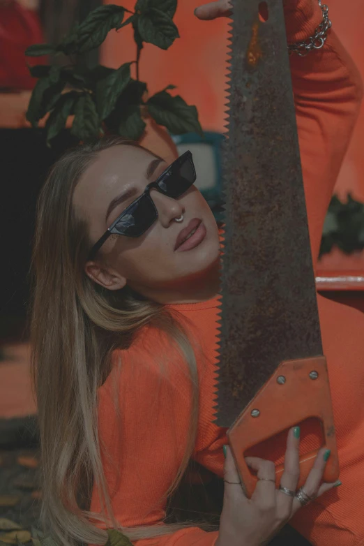 a woman holds up a huge metal knife