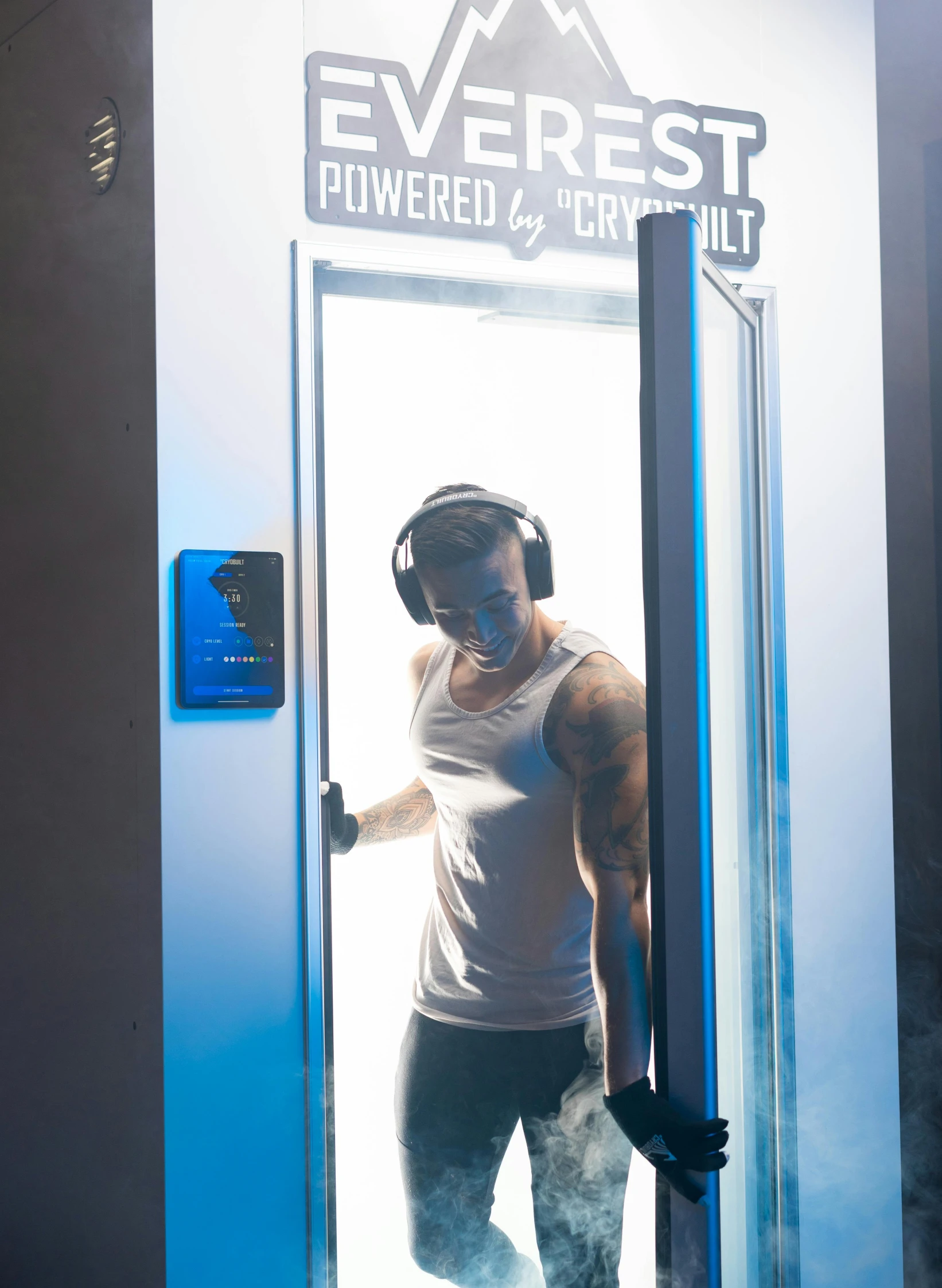 a man with headphones is standing outside of a door