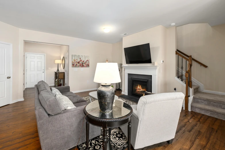 a living room with a fire place and two couches