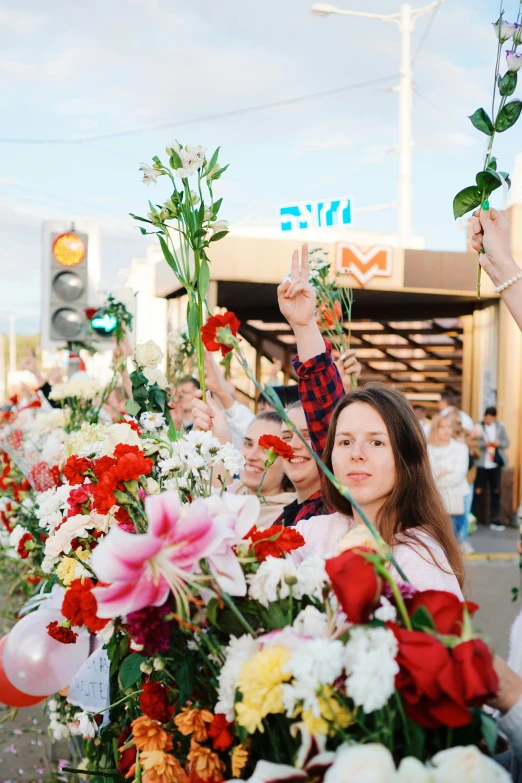 some people hold flower garlands and are looking at soing