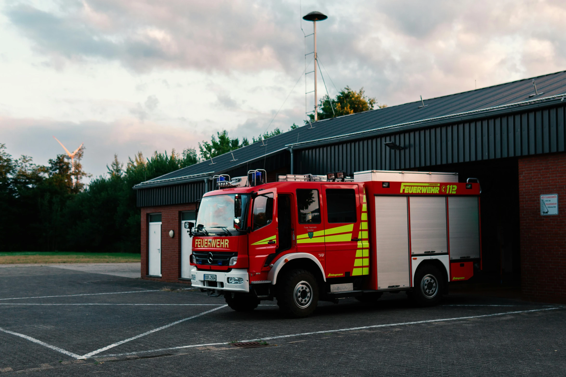 fire trucks are parked in a storage yard