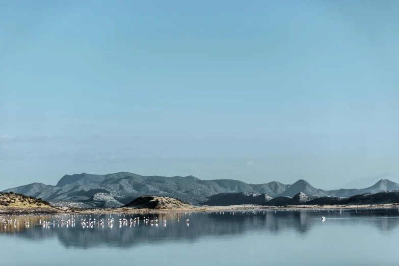 a lake with some mountains in the distance