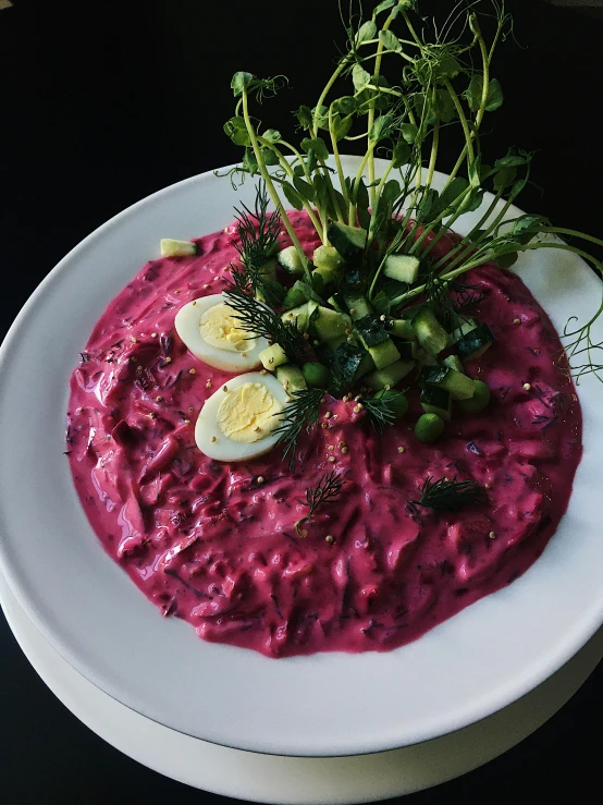 there is a bowl of vegetables and sauce on the table