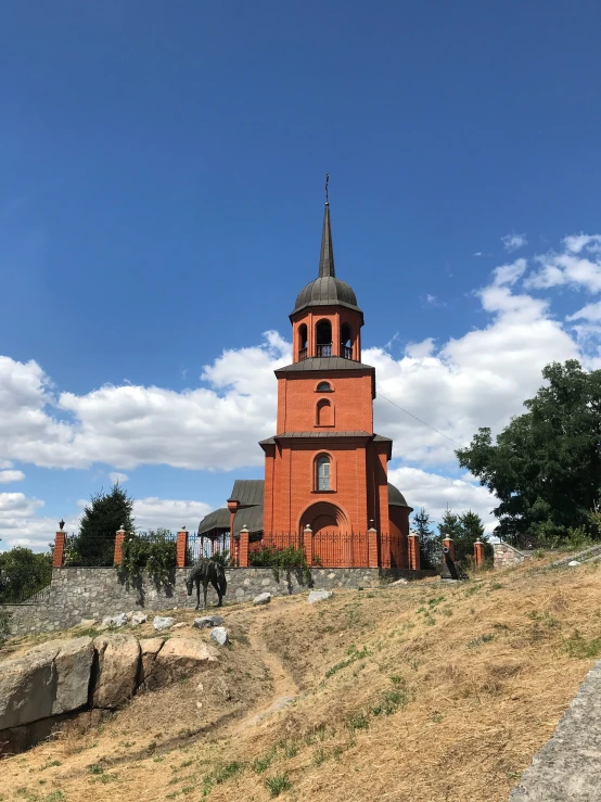 a building on a hill with a clock tower