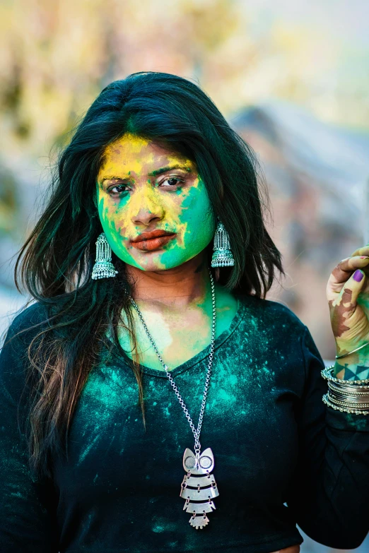 woman covered in powder holding her cell phone and making silly faces