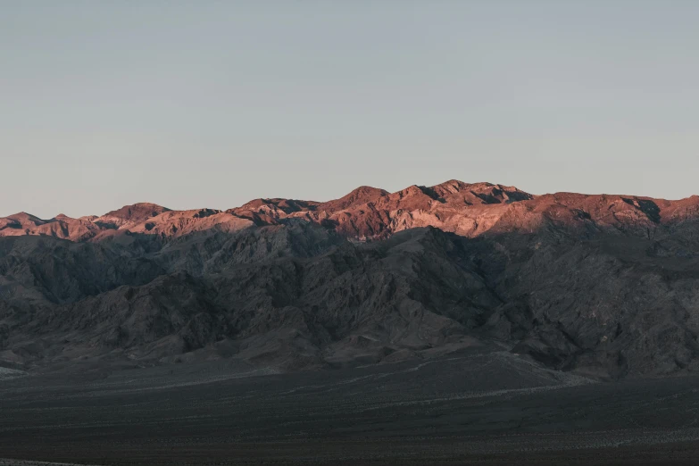 a mountain range and some white and brown rocks