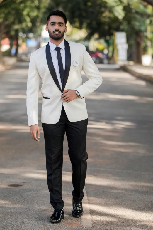 a man is walking down the street wearing a suit and tie