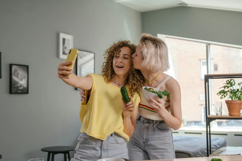 two girls looking at themselves in a mirror in their home