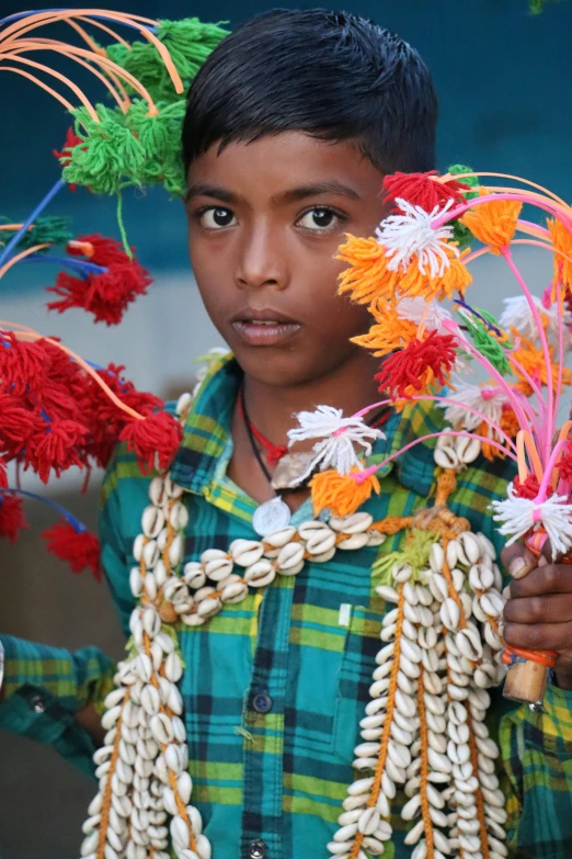 a boy has lots of colorful flowers in his hair