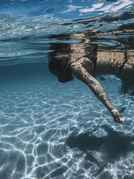 a woman in an underwater po looking for soing to eat