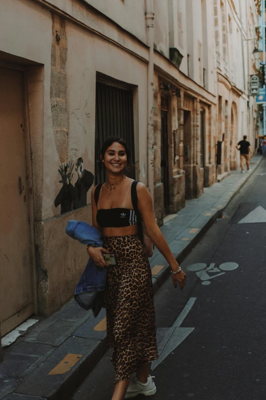 a girl wearing black is walking down the street