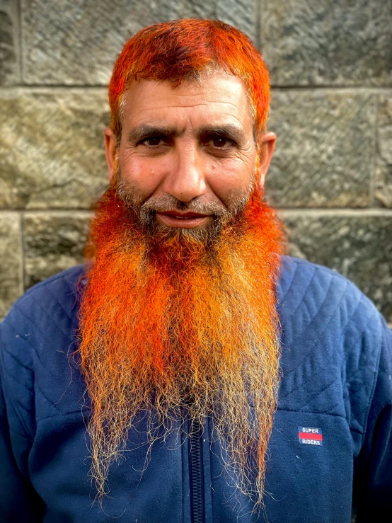 a man with a long red beard has orange hair