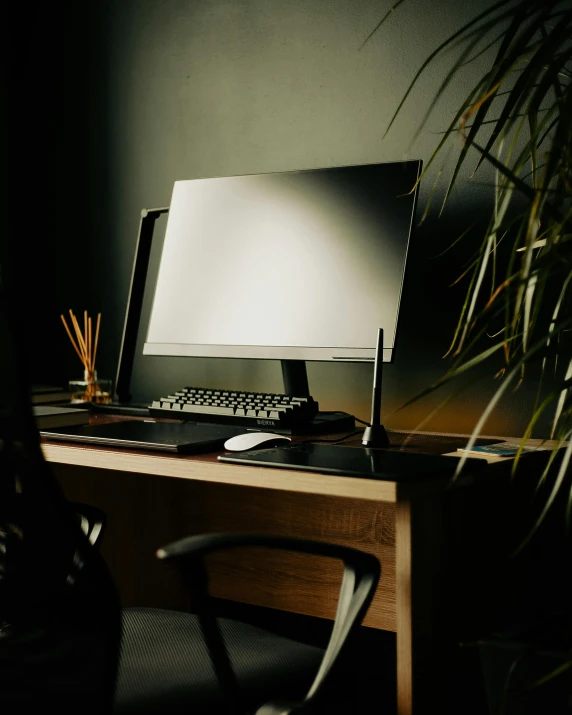 a computer monitor sitting on top of a wooden desk