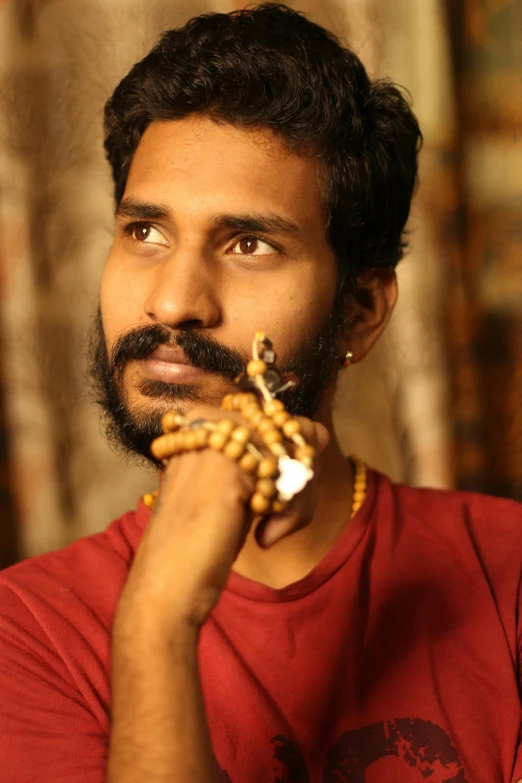 man with moustache holding some kind of food