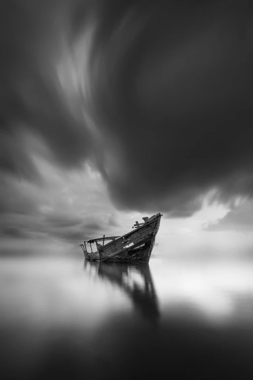 a boat is docked on the water under a cloudy sky