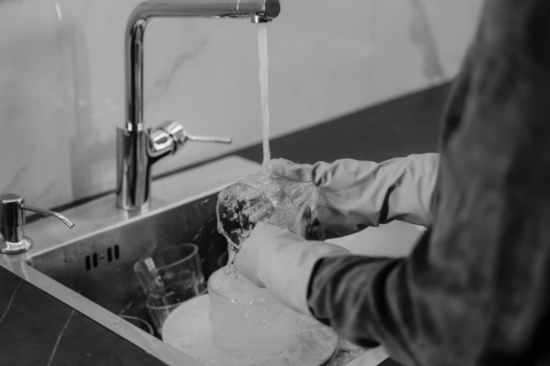 a person is taking a drink from the water faucet