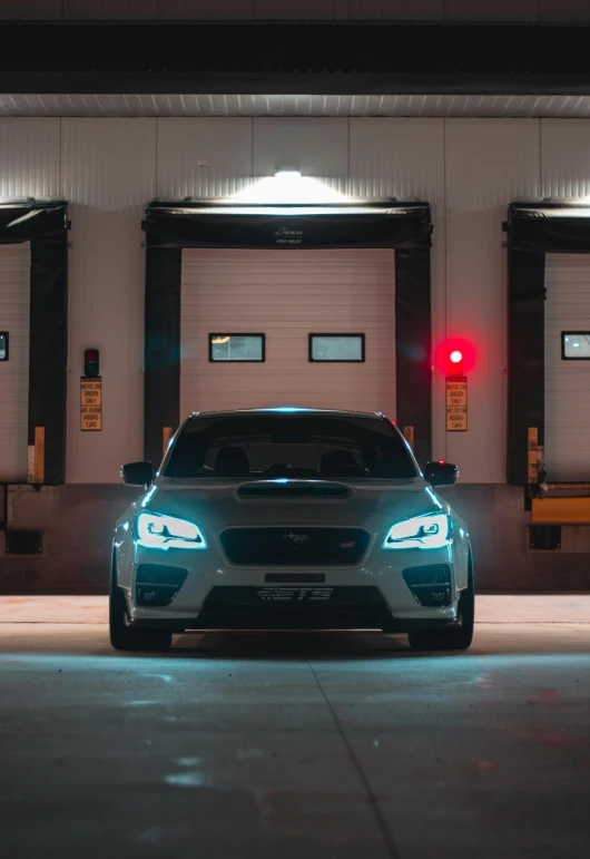 a car parked outside a garage near a traffic signal