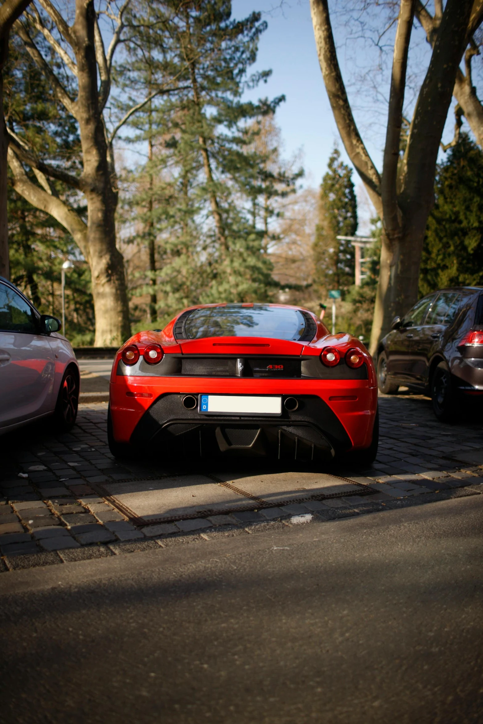 a red sports car parked in a parking lot