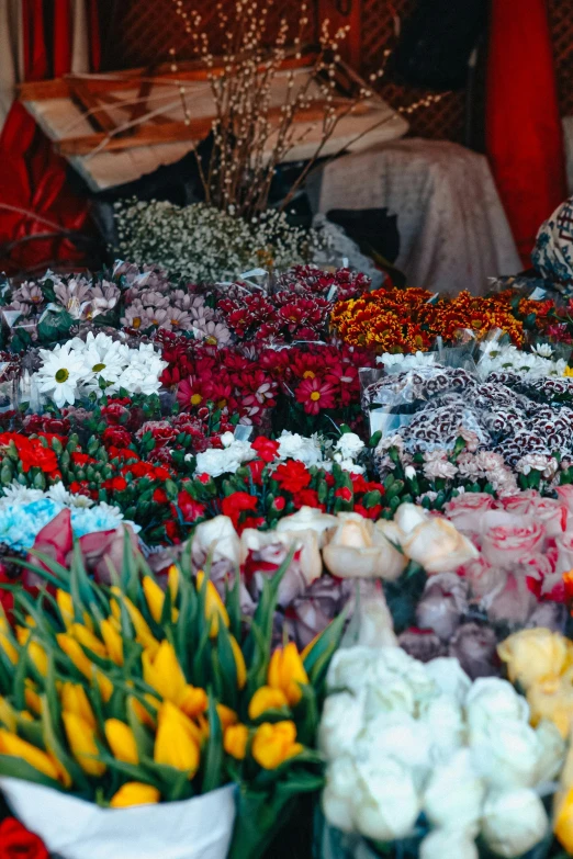 the table has many flower arrangements on it